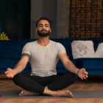 A man practicing mindfulness in a serene setting, illustrating techniques for stress management specifically for men.