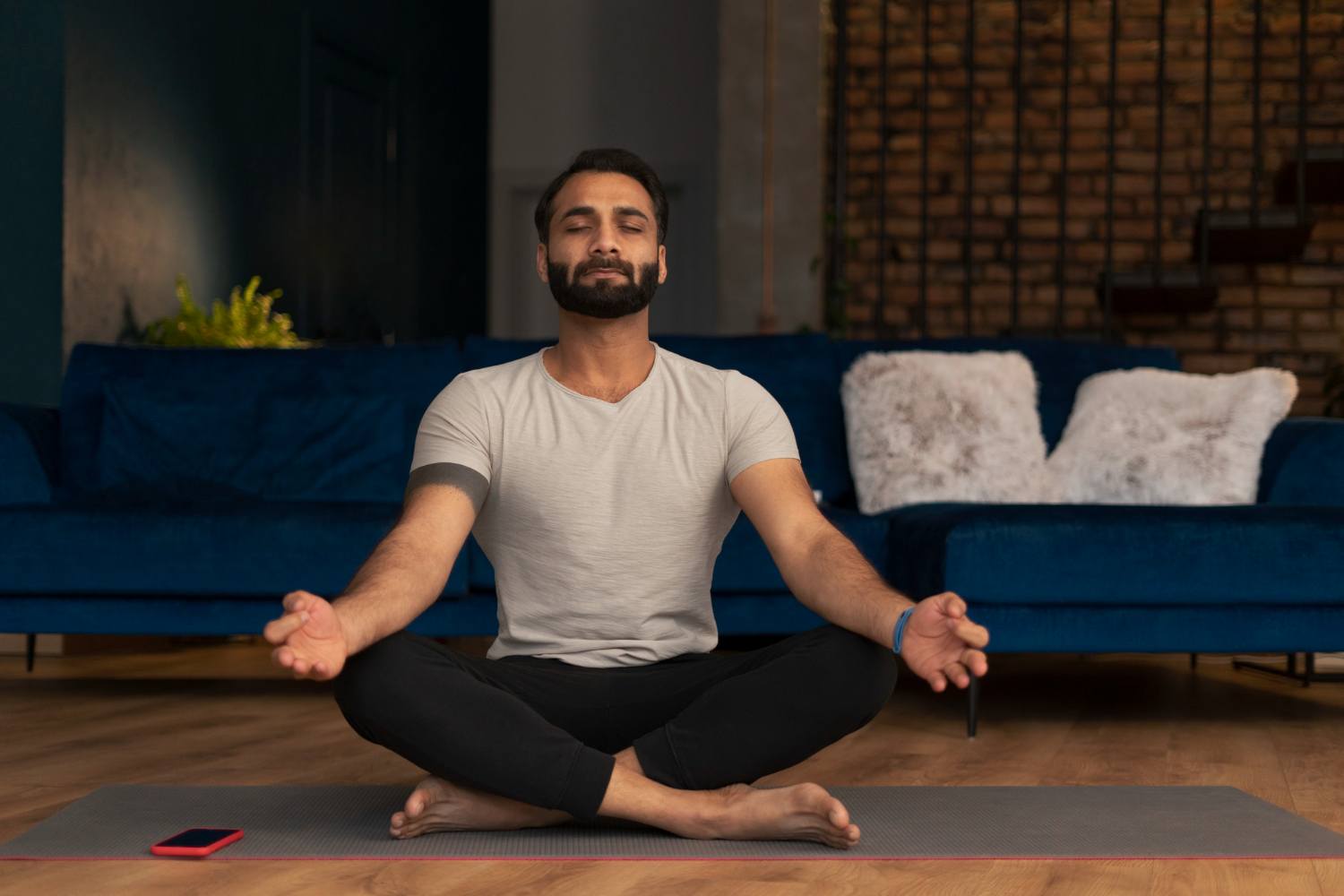 A man practicing mindfulness in a serene setting, illustrating techniques for stress management specifically for men.